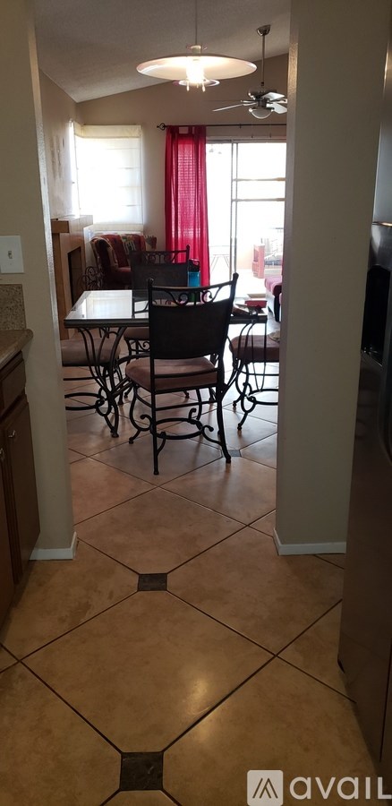 A kitchen with a table and chairs.