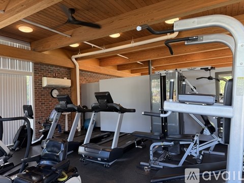 A gym with treadmills, exercise bikes, and other equipment.