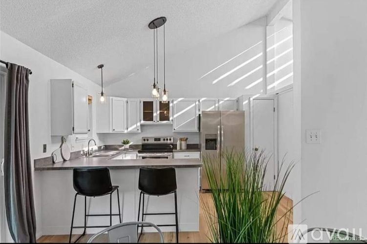 A modern kitchen with white cabinets and a center island.