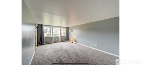A room with a carpeted floor and a sliding glass door.