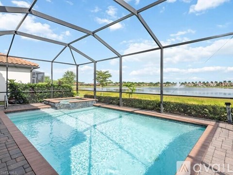 A glass-walled pool area with a clear blue sky.