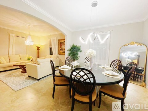 A dining room with a round table set for six.