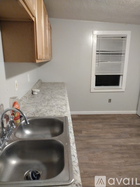 A kitchen with a sink and a window.