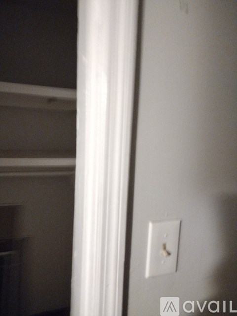 A white light switch on a wall.