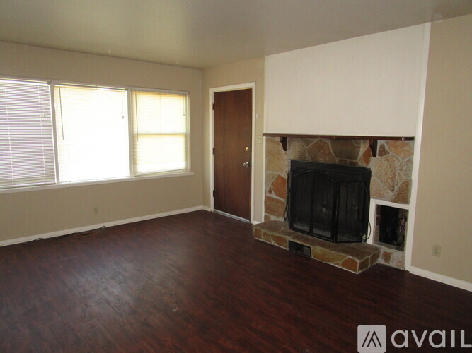 A living room with a fireplace and a television.