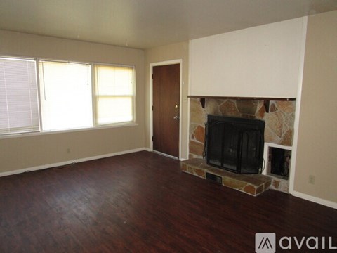 A living room with a fireplace and a television.