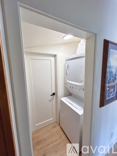 A white washing machine is in a small room.