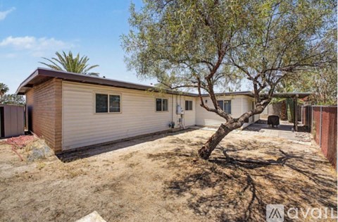 A house with a tree in front of it is for sale.