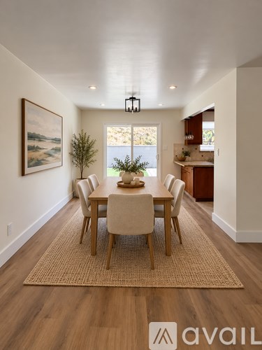 A dining room with a table set for six.