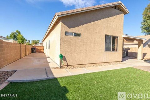 A house with a brown brick exterior and a green lawn in front.