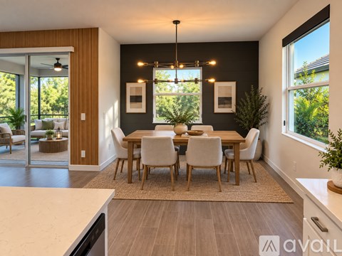 A dining room with a table set for six with a view of the backyard.