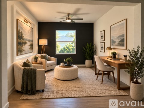 A well-lit, modern living room with a large window, a sofa, a chair, a table, and a potted plant.