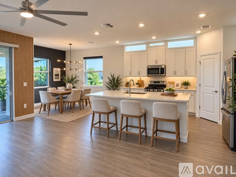 A modern kitchen with a dining table and chairs.