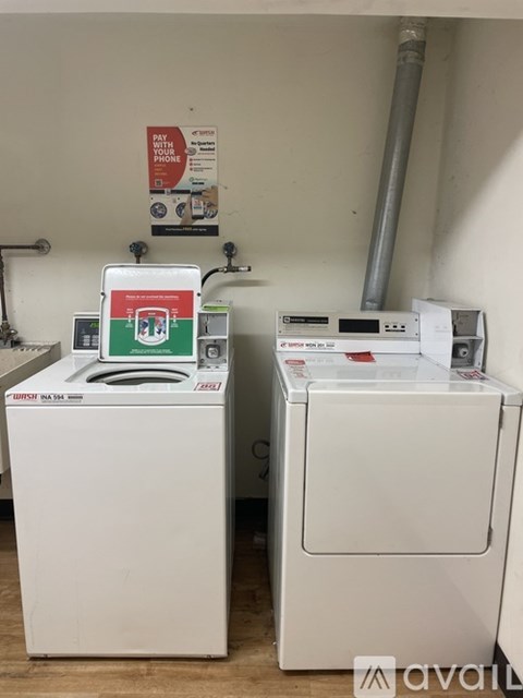 Two white front loading washing machines are available for rent.