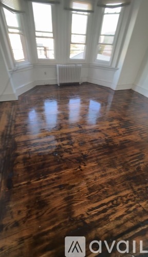 A room with wooden floors and windows.