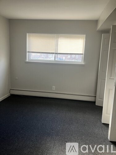 A room with a window and Avail logo on the floor.