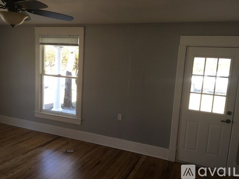 A room with a window and a door.