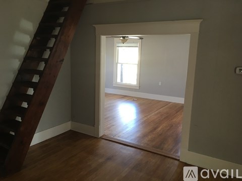 A room with a wooden floor and a window.