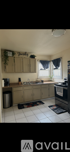 A kitchen with a sign that says "Family" on the wall.