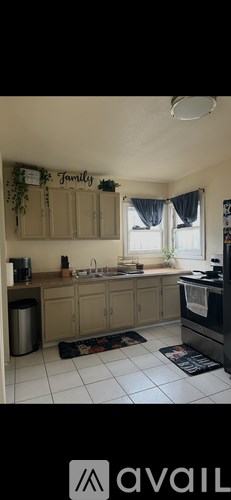 A kitchen with a sign that says "Family" on the wall.