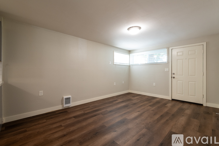 A room with wooden floors and a white door.