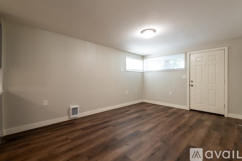 A room with wooden floors and a white door.