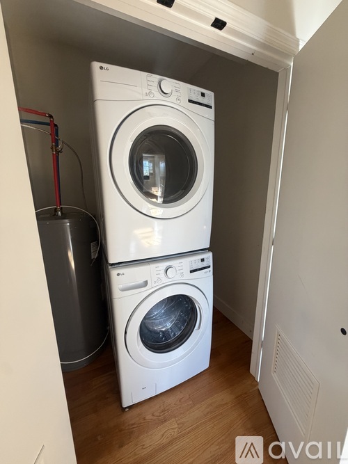 A stacked washer and dryer in a small laundry room.