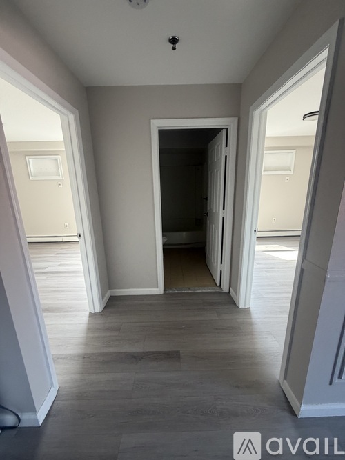 A room with a wooden floor and a white door.