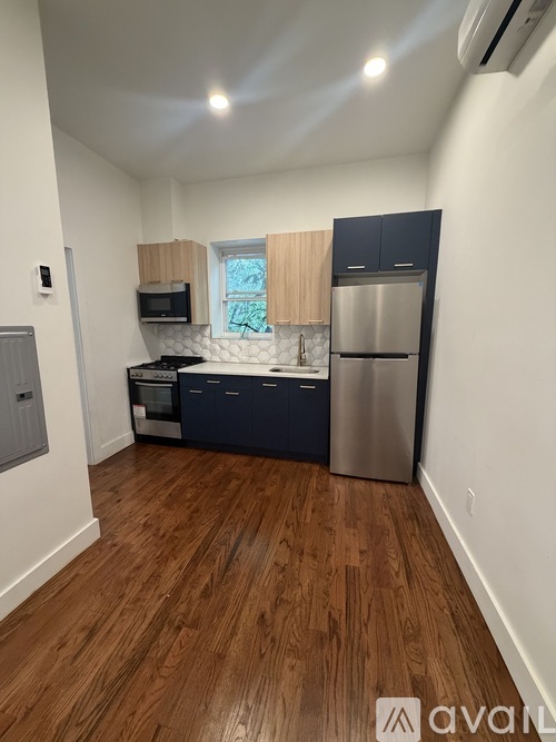 A kitchen with wooden floors and stainless steel appliances.