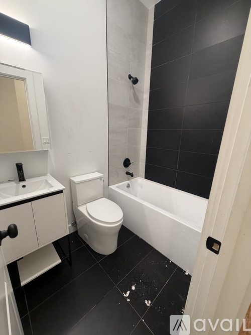 A bathroom with a toilet, sink, and bathtub.