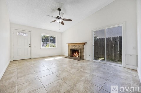 A living room with a fireplace and sliding glass doors.