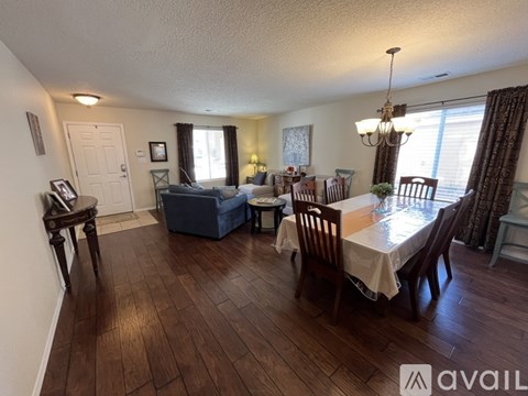 A dining room with a table set for six.