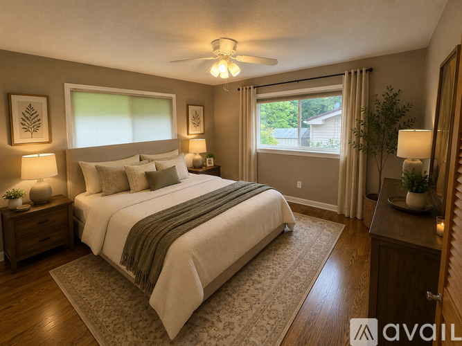 A well-lit bedroom with a large bed and a view of the backyard.