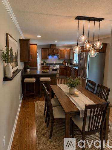 A dining room with a wooden table and chairs.