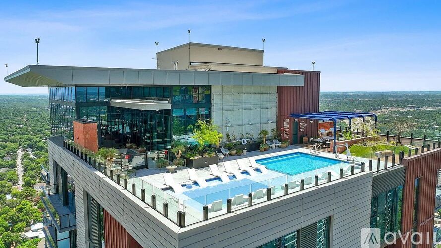 A modern building with a pool on the roof.