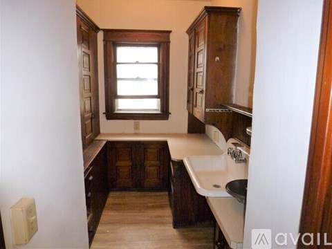 A small bathroom with a sink, toilet and window.