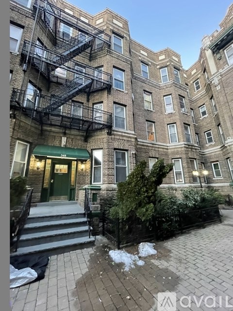 A building with a green awning and a fire escape.