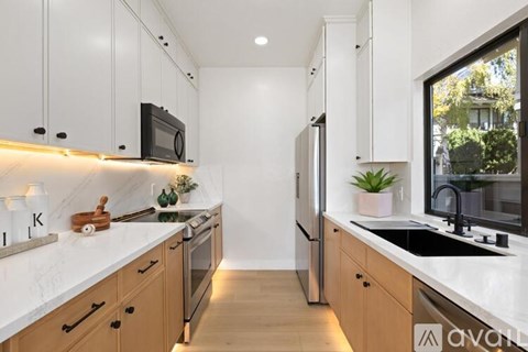 A kitchen with wooden cabinets and a white countertop.