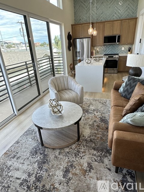 A living room with a white chair and a round table with a metal object on it.