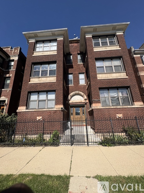 A brick building with a brown door and windows.