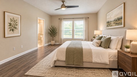 A bedroom with a large bed and a ceiling fan.