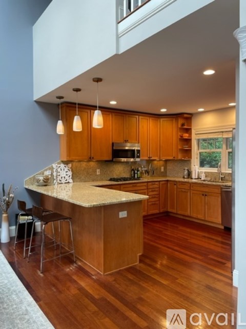 A kitchen with wooden cabinets and a central island.