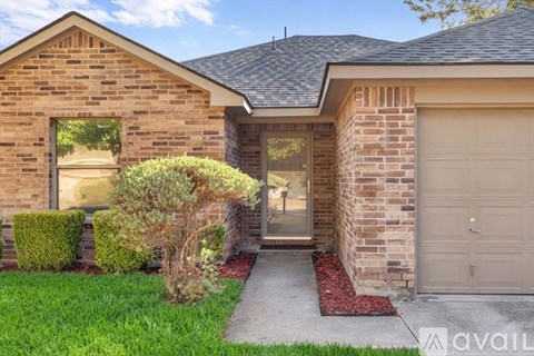 A house with a brick exterior and a garage door.