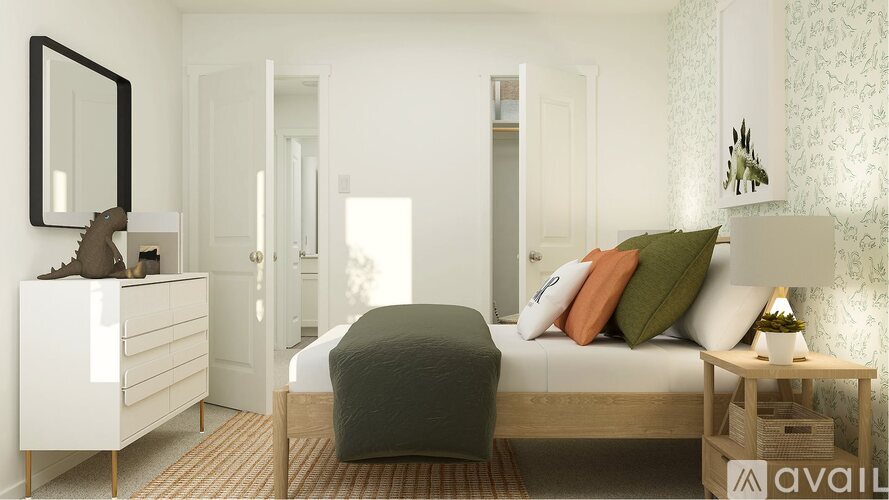 A bedroom with a bed, nightstand, and a dresser with a mirror.