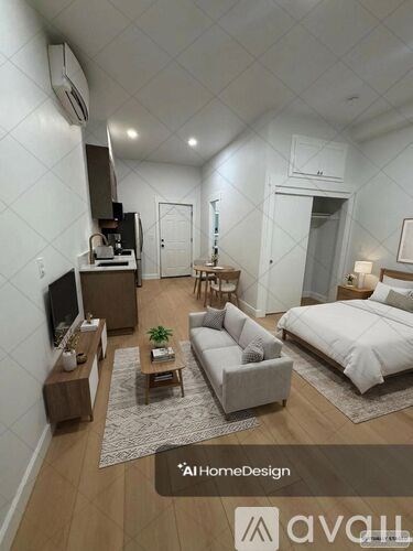 A well-lit, modern bedroom with a large bed, a couch, a coffee table, and a television.