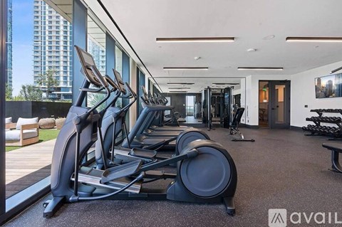 A gym with treadmills, elliptical machines, and other exercise equipment.