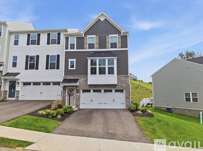 A modern two-story house with a garage is for sale.