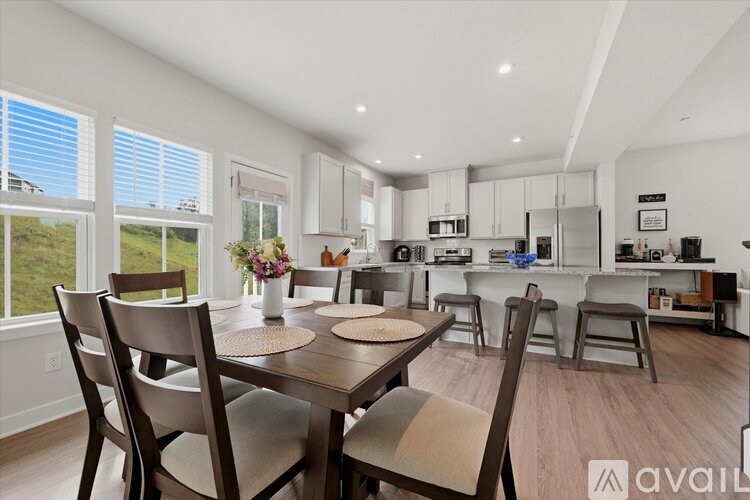A modern kitchen with a dining table set for four.