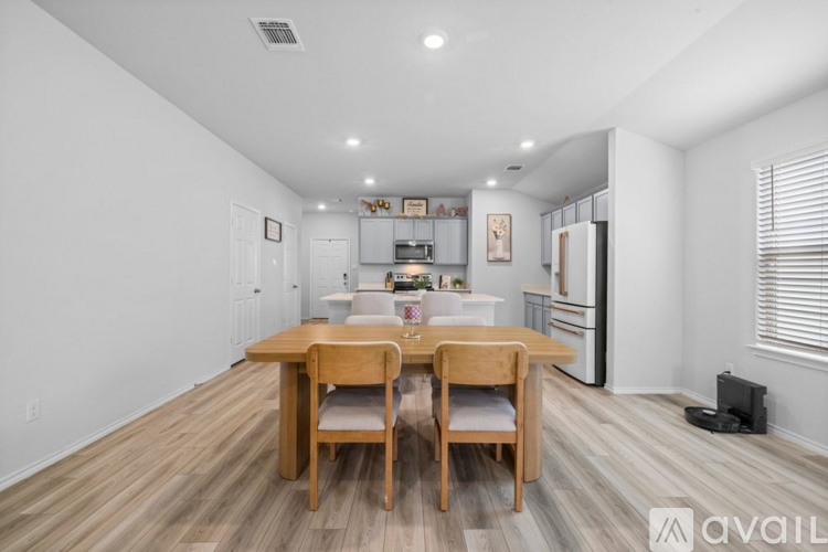 A dining room with a wooden table and chairs.
