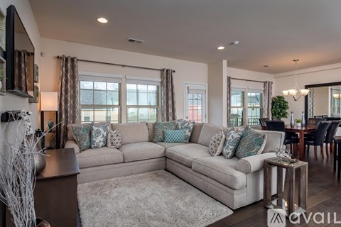 A living room with a large sectional sofa and a coffee table.